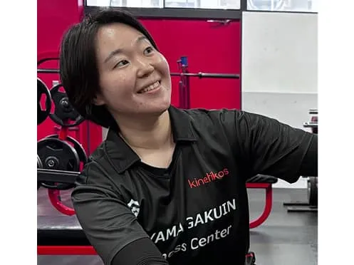 うつ伏せになっている人に施術をする学生と、指導している講師の様子