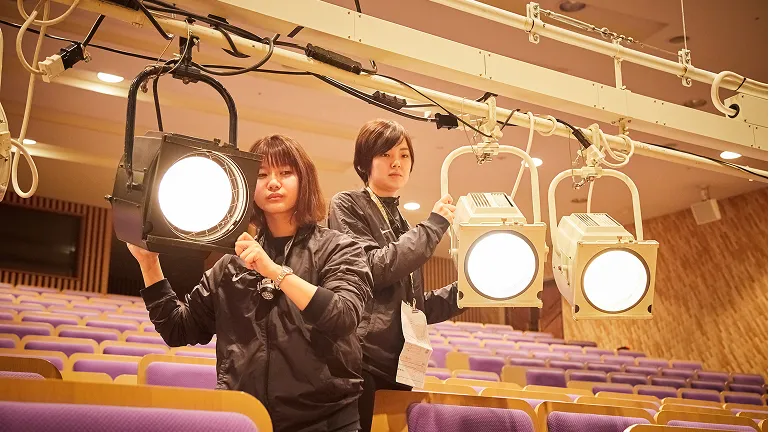 学生たちが照明器具の設置をしている様子