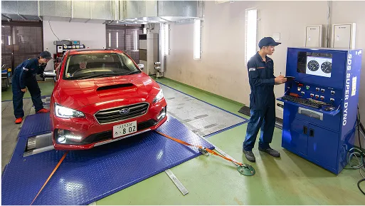 学生たちがシャシダイナモを使用して測定している様子