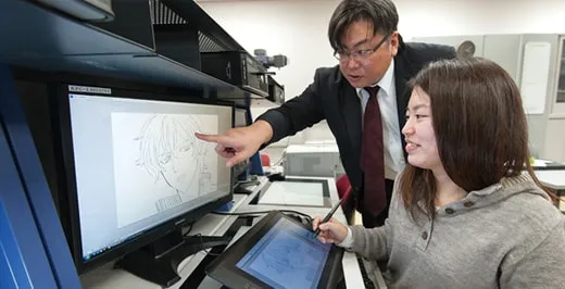 ディスプレイを指差しての作画指導の様子