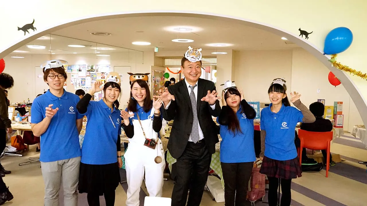 動物のお面を頭に付けた担当学生たちと、トラのお面を被り、がおーのポーズで楽しく撮影