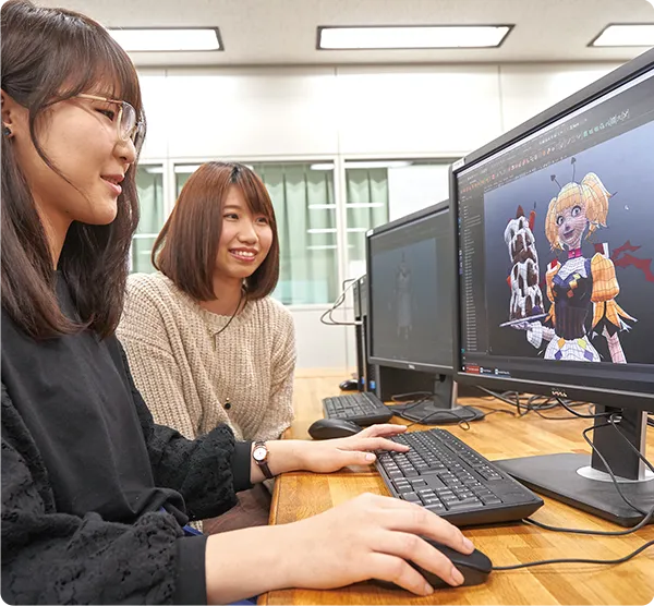 ２名の学生がキャラクターのグラフィックデザインを行っている様子