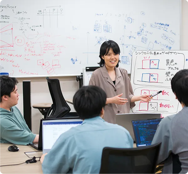 複数の学生がゲームデザインなどについて議論している様子